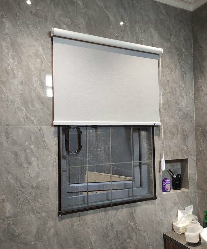 Window fitted with a roller blind